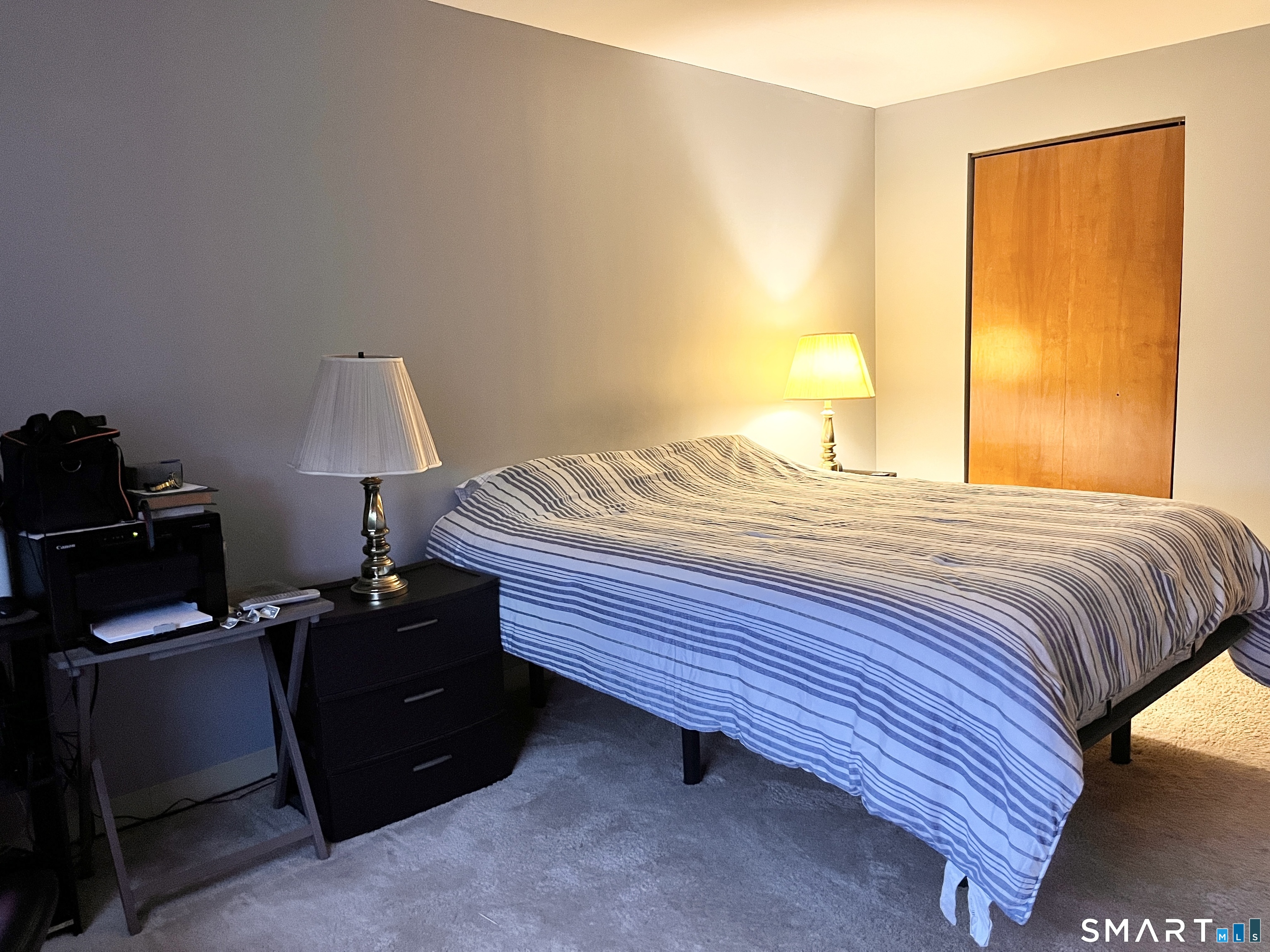 96 Putter Drive, Unit 510N Wallingford, CT 06492 - Photo 17 of 23 a bedroom with a bed and a lamp