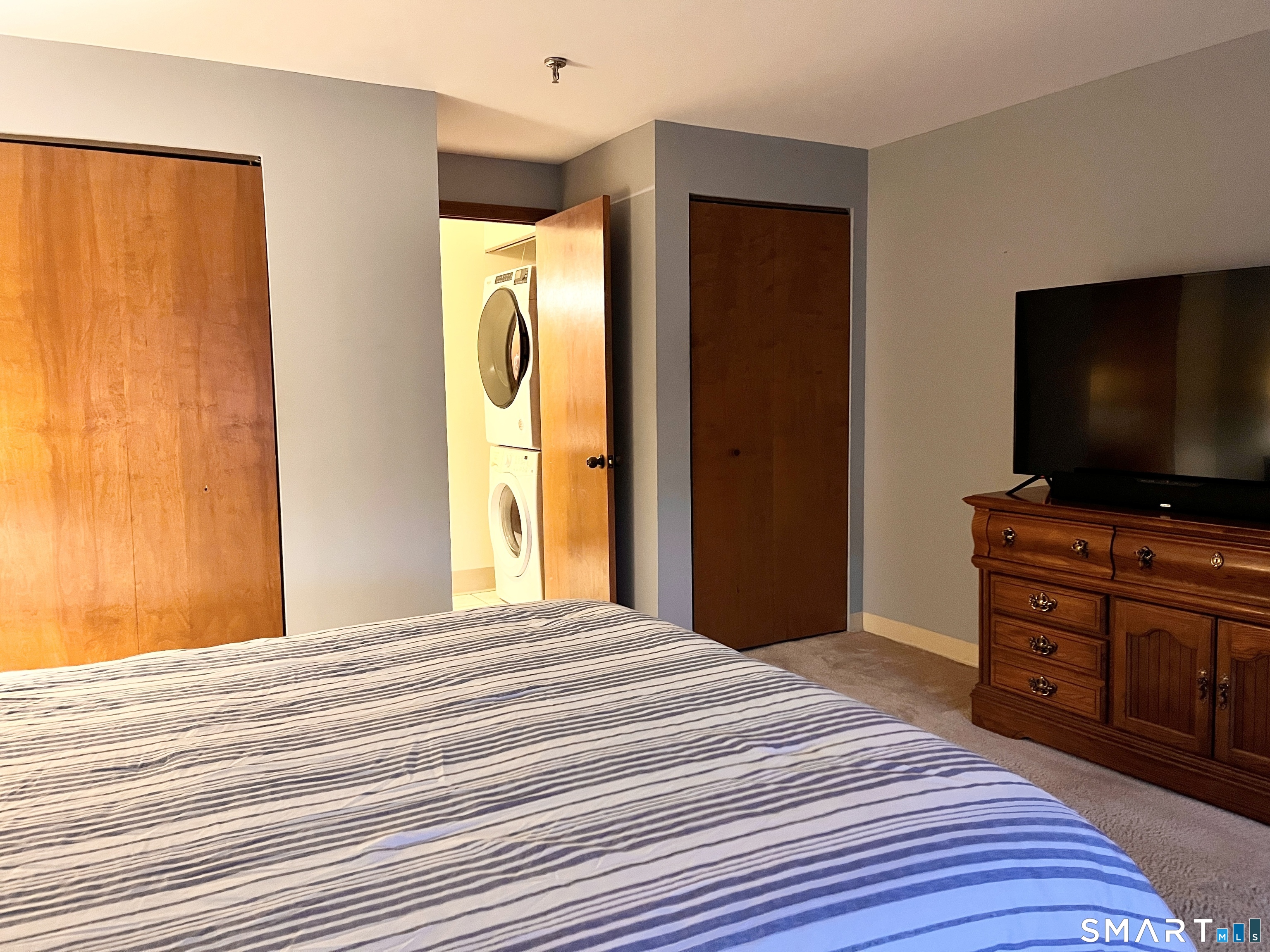 96 Putter Drive, Unit 510N Wallingford, CT 06492 - Photo 19 of 23 a bedroom with a bed and a flat screen tv