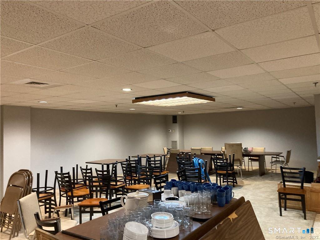 96 Putter Drive, Unit 510N Wallingford, CT 06492 - Photo 21 of 23 a room with lots of chairs and couches