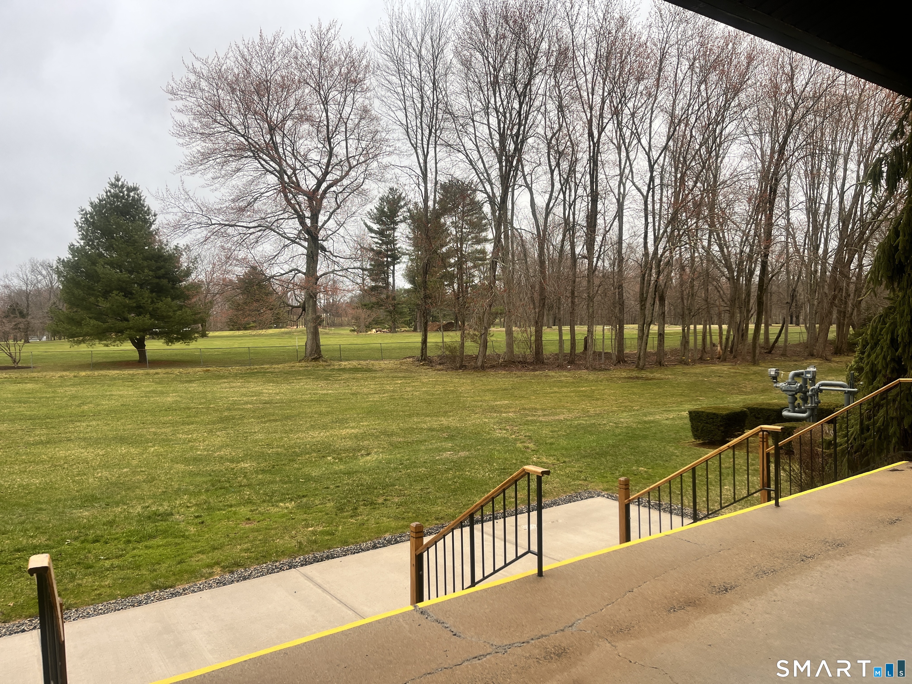 96 Putter Drive, Unit 510N Wallingford, CT 06492 - Photo 6 of 23 a view of a swimming pool with a lawn chairs under an umbrella