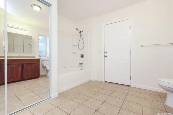 a spacious bathroom with a granite countertop sink a toilet and shower