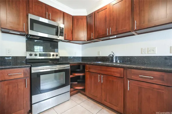 a kitchen with granite countertop cabinets stainless steel appliances and a sink