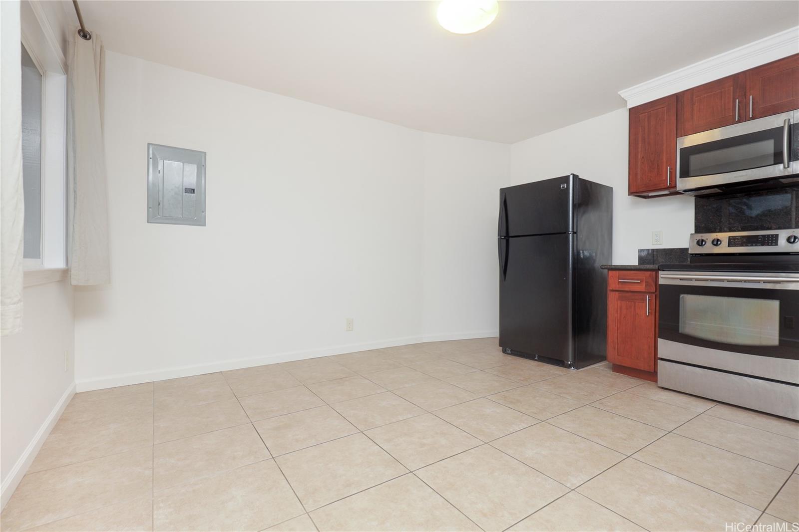 99-036 Moanalua Road, Unit A1 Aiea, HI 96701 - Photo 4 of 18 a kitchen with stainless steel appliances a refrigerator and a stove top oven