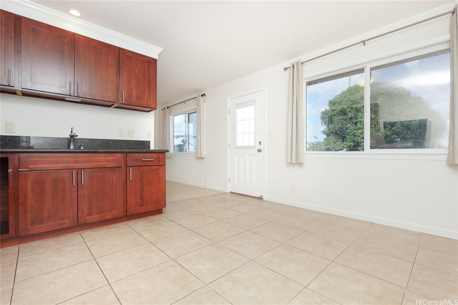 99-036 Moanalua Road, Unit A1 Aiea, HI 96701 - Photo 5 of 18 a kitchen with a cabinets a sink and a window