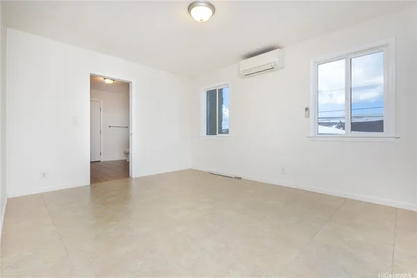 an empty room with windows and closet