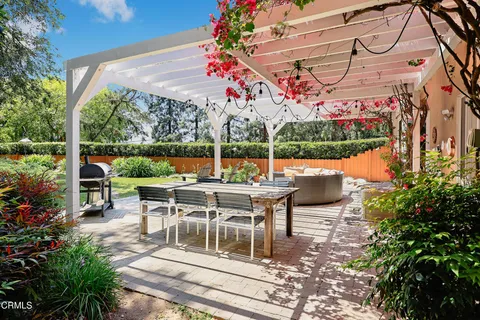 a view of a chairs and table in patio with a yard