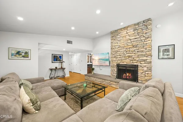 a living room with furniture and a fireplace