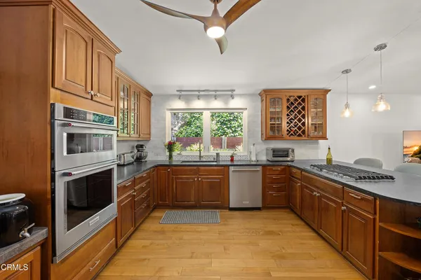 a kitchen with stainless steel appliances granite countertop a stove and a sink
