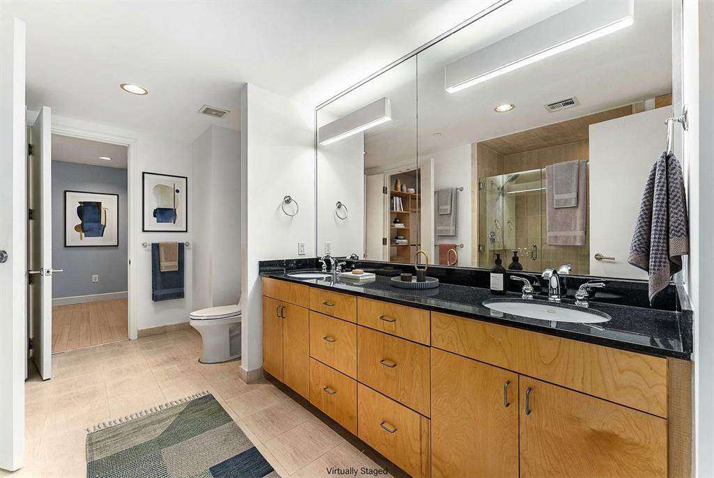 1505 Elm Street, Unit 1003 Dallas, TX 75201 - Photo 13 of 20 a spacious bathroom with double sink and a large mirror