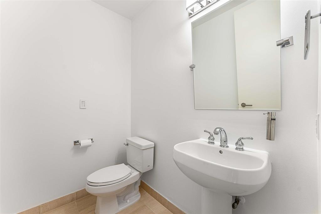 1505 Elm Street, Unit 1003 Dallas, TX 75201 - Photo 14 of 33 a bathroom with a sink a toilet and mirror