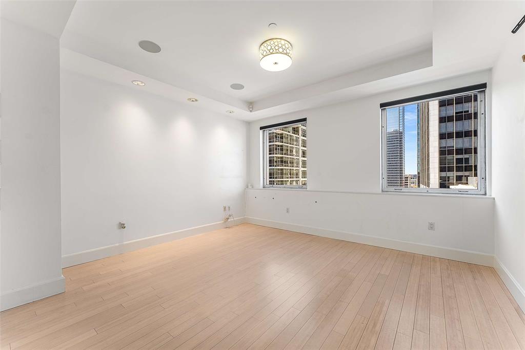 1505 Elm Street, Unit 1003 Dallas, TX 75201 - Photo 17 of 33 a view of empty room with wooden floor and fan