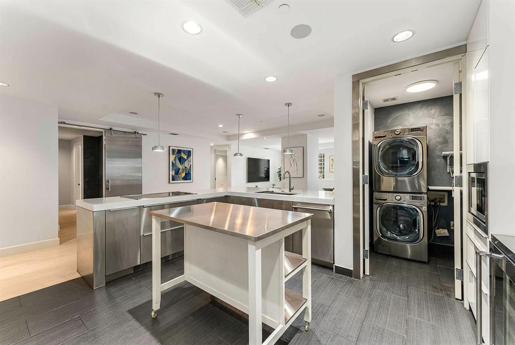 1505 Elm Street, Unit 1003 Dallas, TX 75201 - Photo 6 of 20 a large white kitchen with a stove top oven a sink and dishwasher