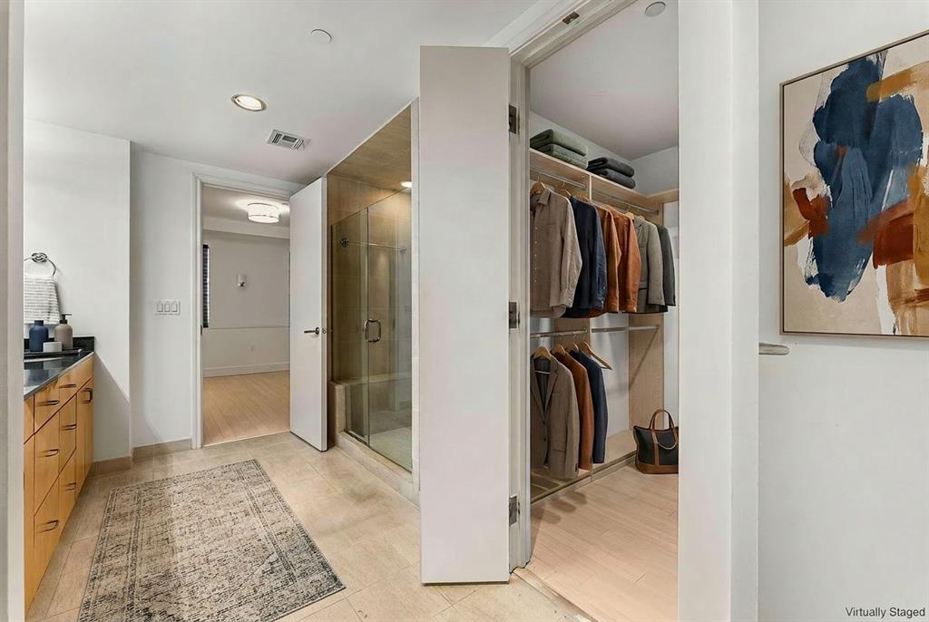 1505 Elm Street, Unit 1003 Dallas, TX 75201 - Photo 10 of 20 a view of walk in closet with clothes and shoes