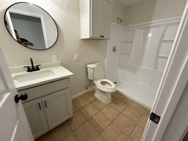 a bathroom with a toilet a sink and a mirror