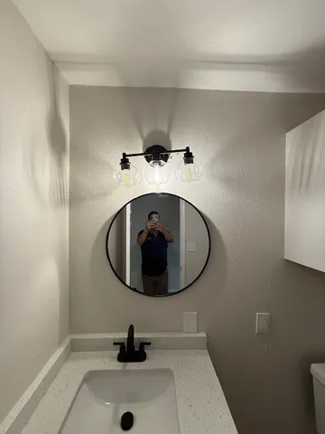a bathroom with a sink and mirror