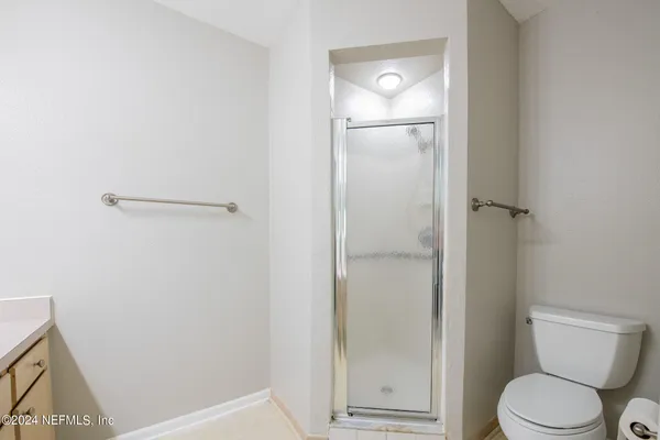 a bathroom with a toilet and a shower