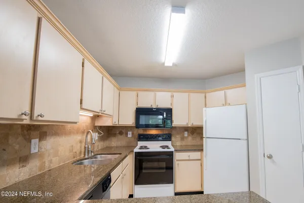 a kitchen with a refrigerator sink and microwave