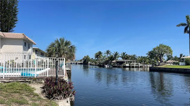 a view of a lake with a table and chairs