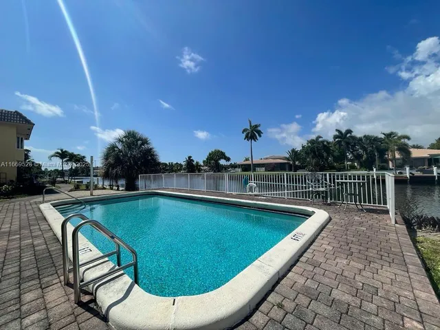 an aerial view of house with yard swimming pool and outdoor seating