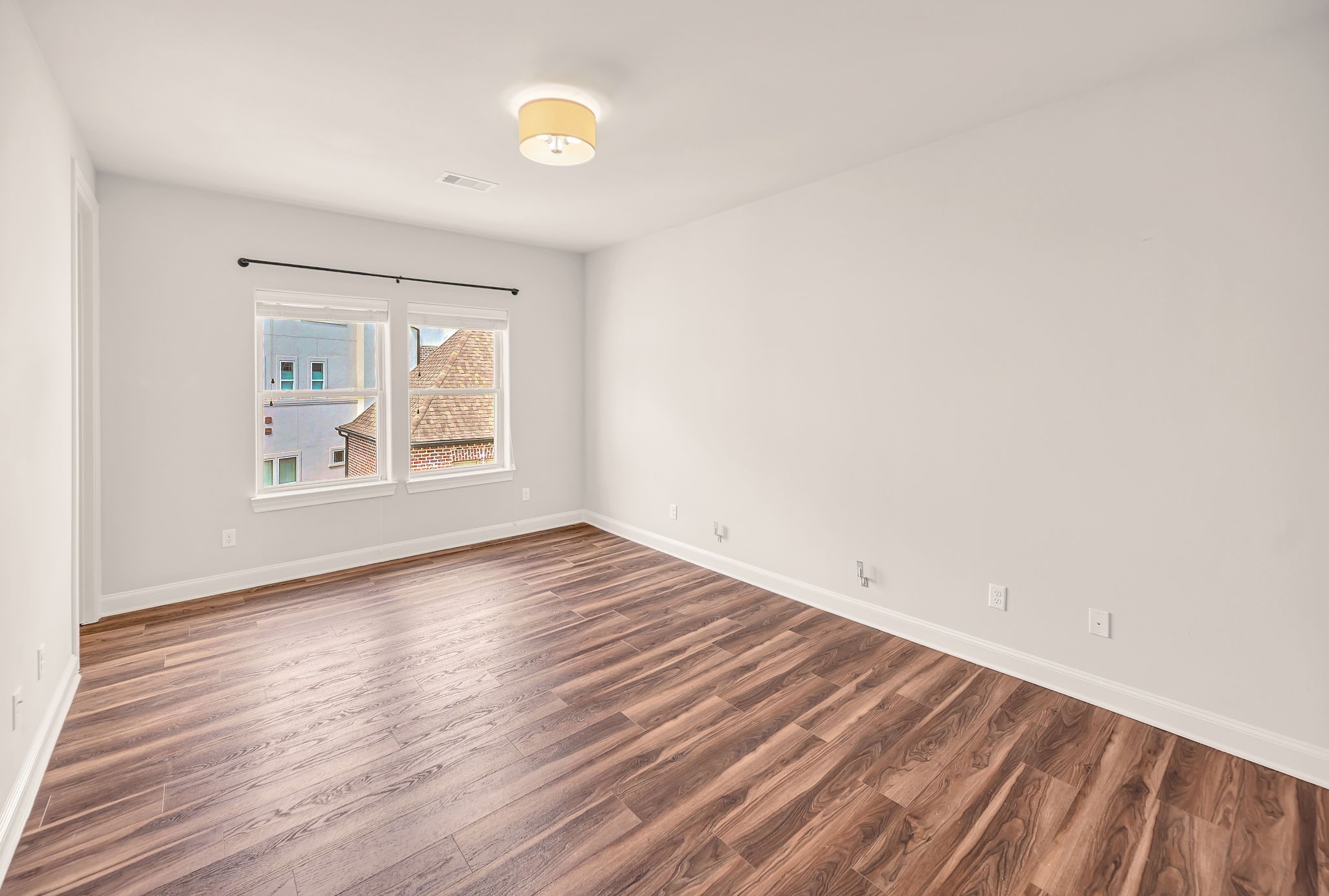 9644 Knight Road Houston, TX 77045 - Photo 15 of 28 an empty room with wooden floor and windows