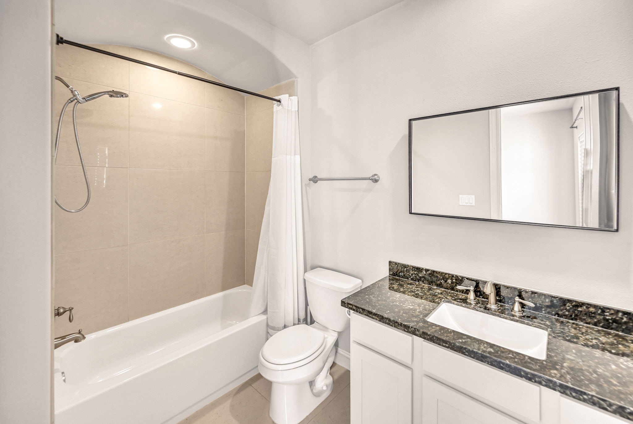 9644 Knight Road Houston, TX 77045 - Photo 16 of 28 a bathroom with a granite countertop sink toilet and shower