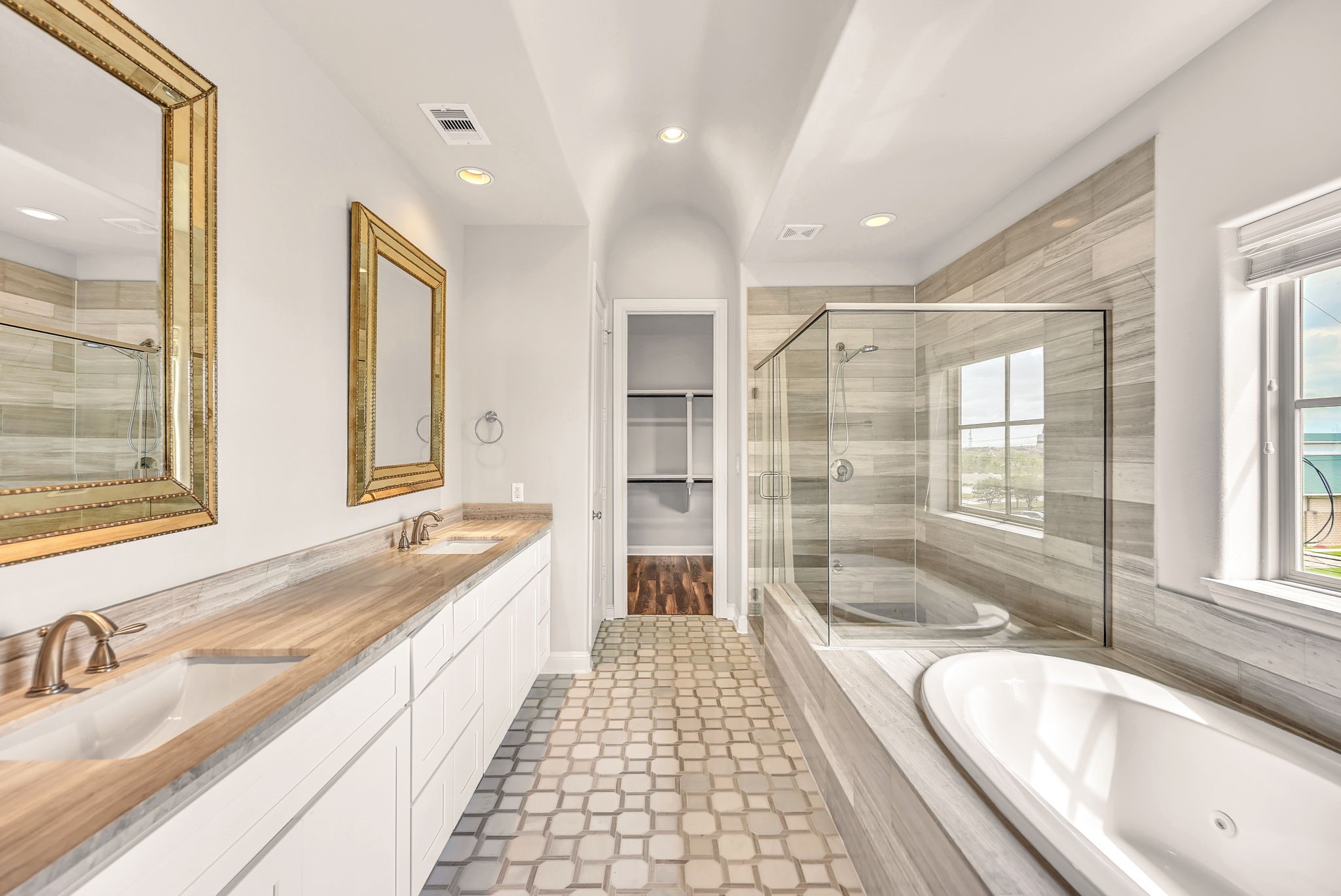 9644 Knight Road Houston, TX 77045 - Photo 20 of 28 a large spacious bathroom with a granite countertop tub sink shower and mirror