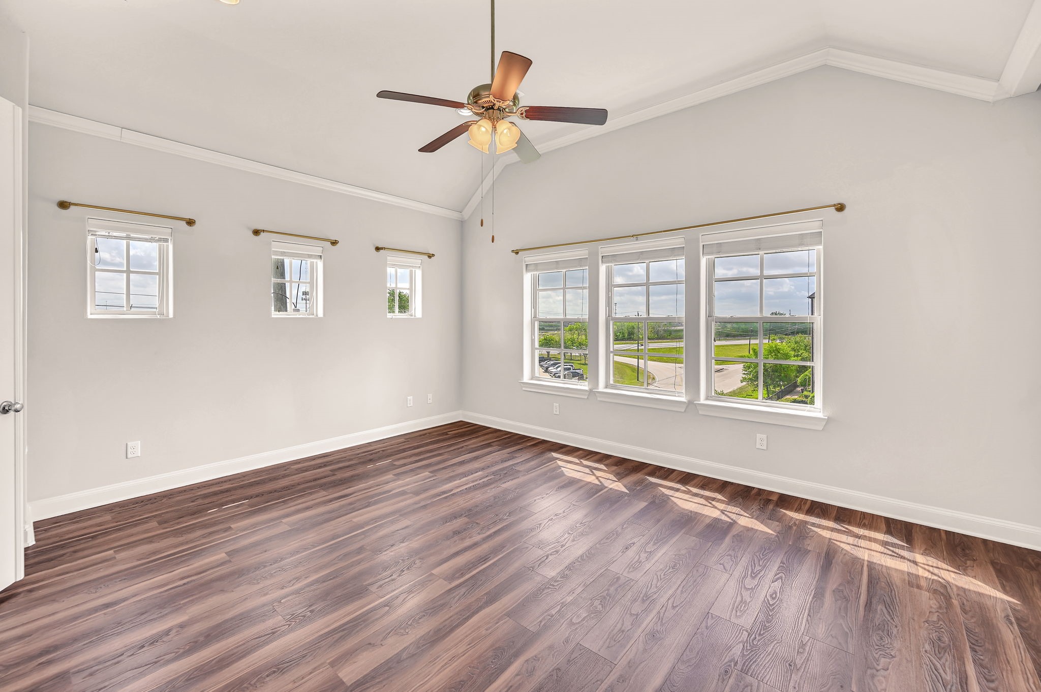 9644 Knight Road Houston, TX 77045 - Photo 21 of 28 a view of an empty room with wooden floor and a window