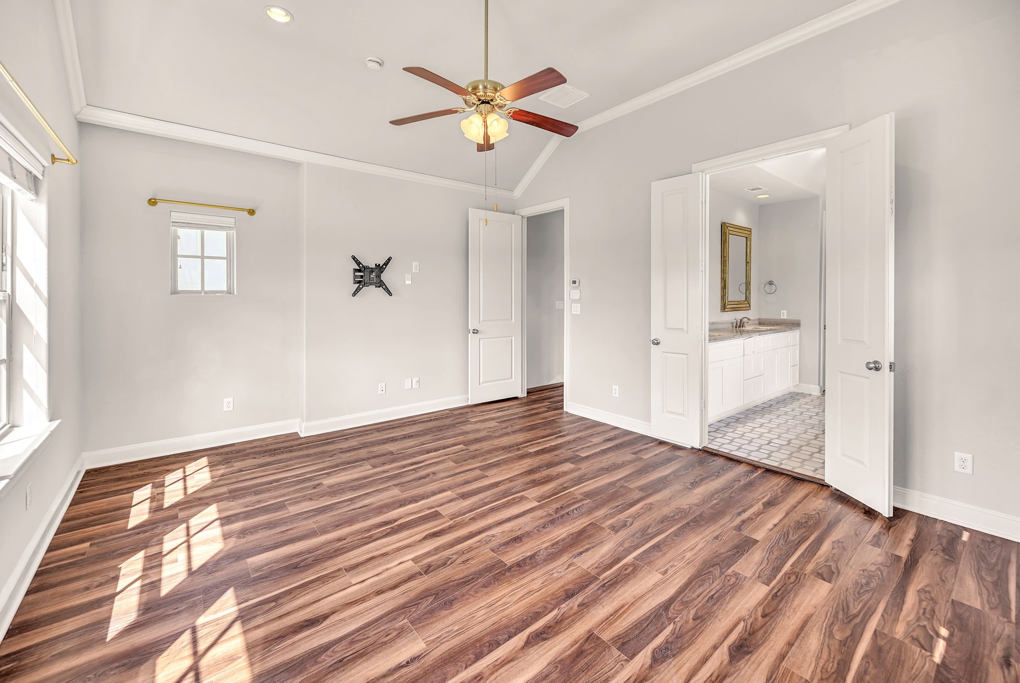 9644 Knight Road Houston, TX 77045 - Photo 22 of 28 a view of a livingroom with wooden floor and a ceiling fan