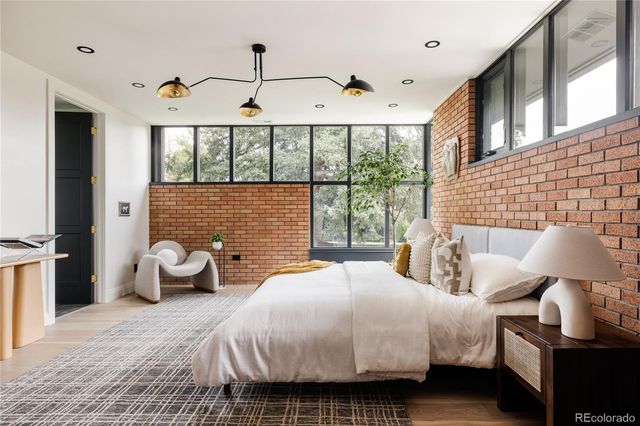 a spacious bedroom with a bed and a large window