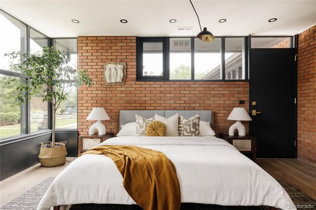 a bedroom with a bed and a night stand