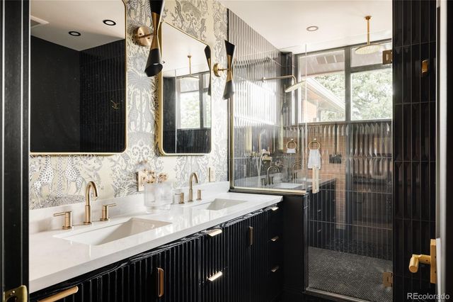 a bathroom with double vanity and a two mirror