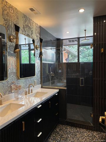 a bathroom with a sink a toilet a mirror and window