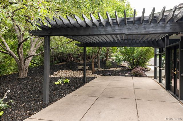 a view of a patio with a table and chairs next to a yard