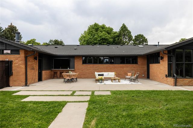 a view of a house with backyard sitting area and garden