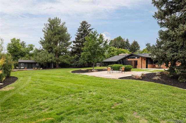 a view of a house with a yard patio and swimming pool