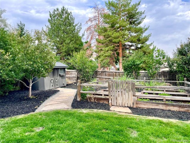 a view of a house with backyard and a tree