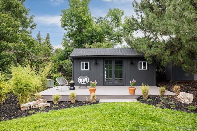 a front view of a house with a yard and sitting area