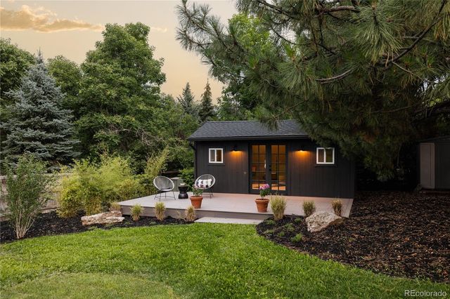 a view of a house with backyard and sitting area