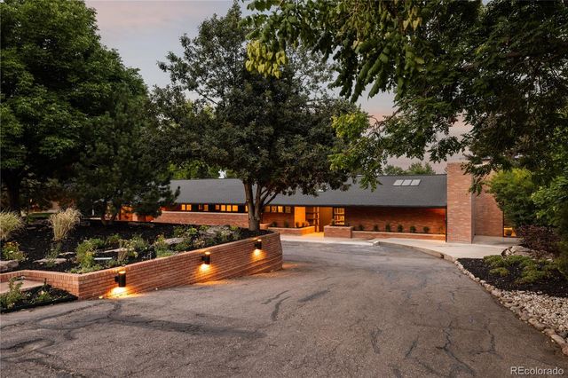 a view of a swimming pool with a yard and plants