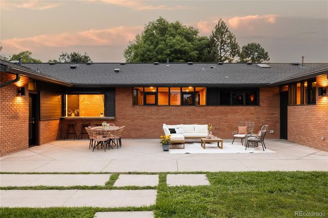 a view of a patio with table and chairs and potted plants