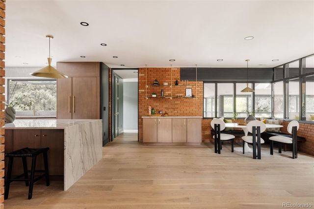 a living room with furniture large window and outdoor view