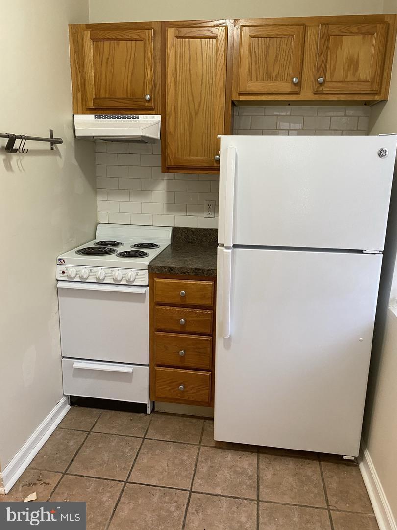 460 Moyer Street Philadelphia, PA 19125 - Photo 4 of 10 a white refrigerator freezer and a stove sitting inside of a kitchen