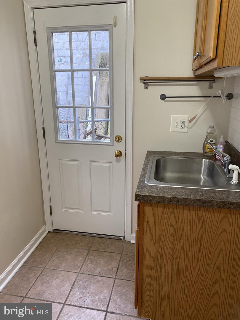 460 Moyer Street Philadelphia, PA 19125 - Photo 5 of 10 a kitchen with granite countertop white cabinets and a sink