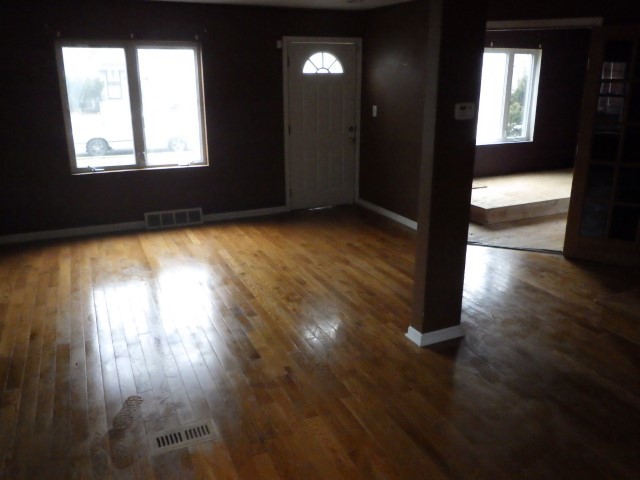 3756 West 85th Place Chicago, IL 60652 - Photo 3 of 19 an empty room with wooden floor and windows