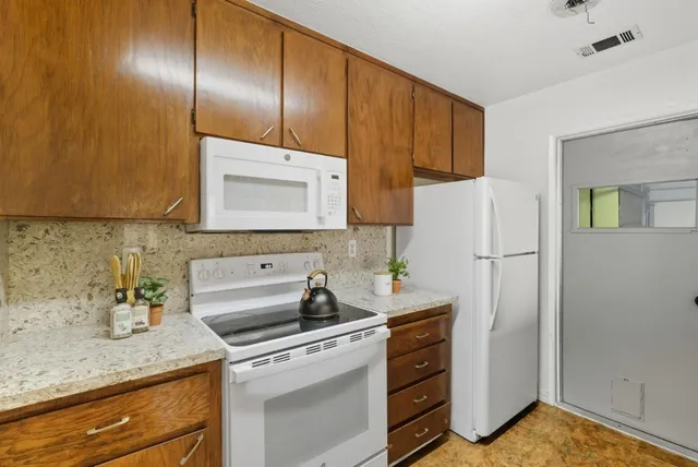 a kitchen with a sink cabinets and appliances