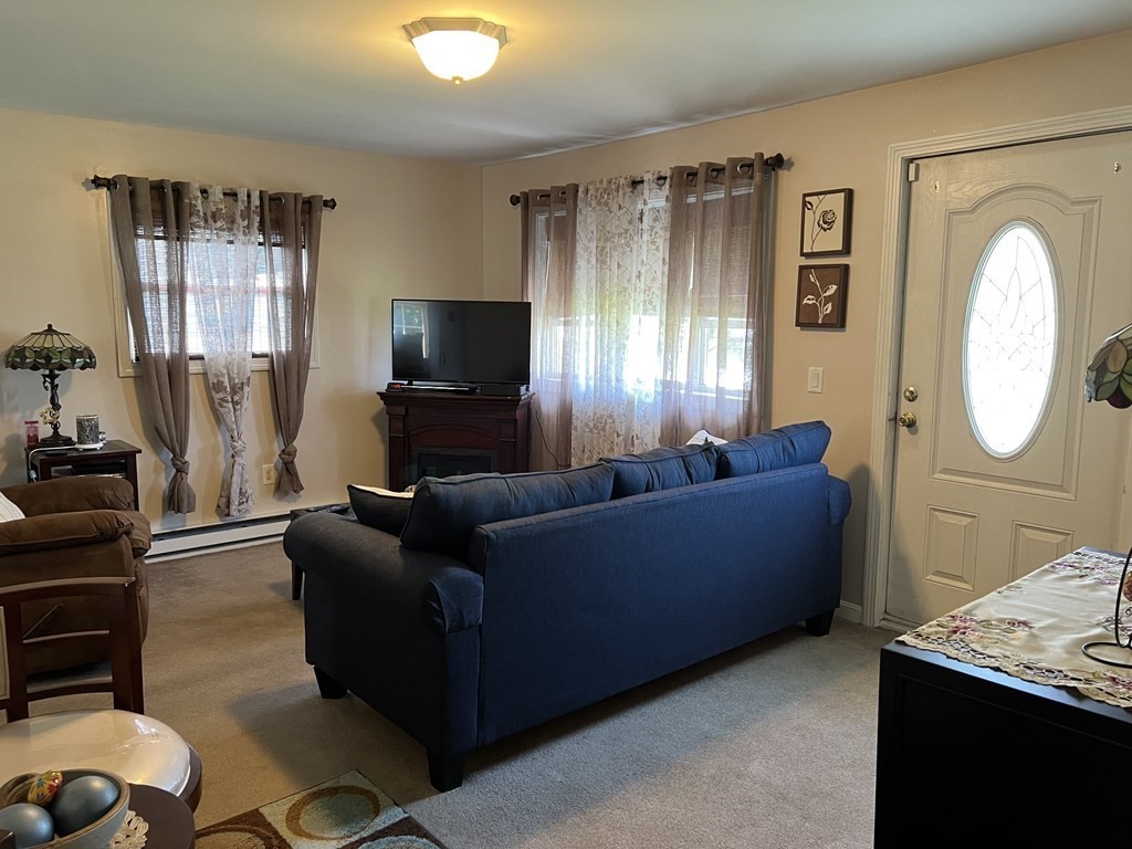 33 Merrill Road Springfield, MA 01119 - Photo 5 of 18 a living room with furniture and a flat screen tv