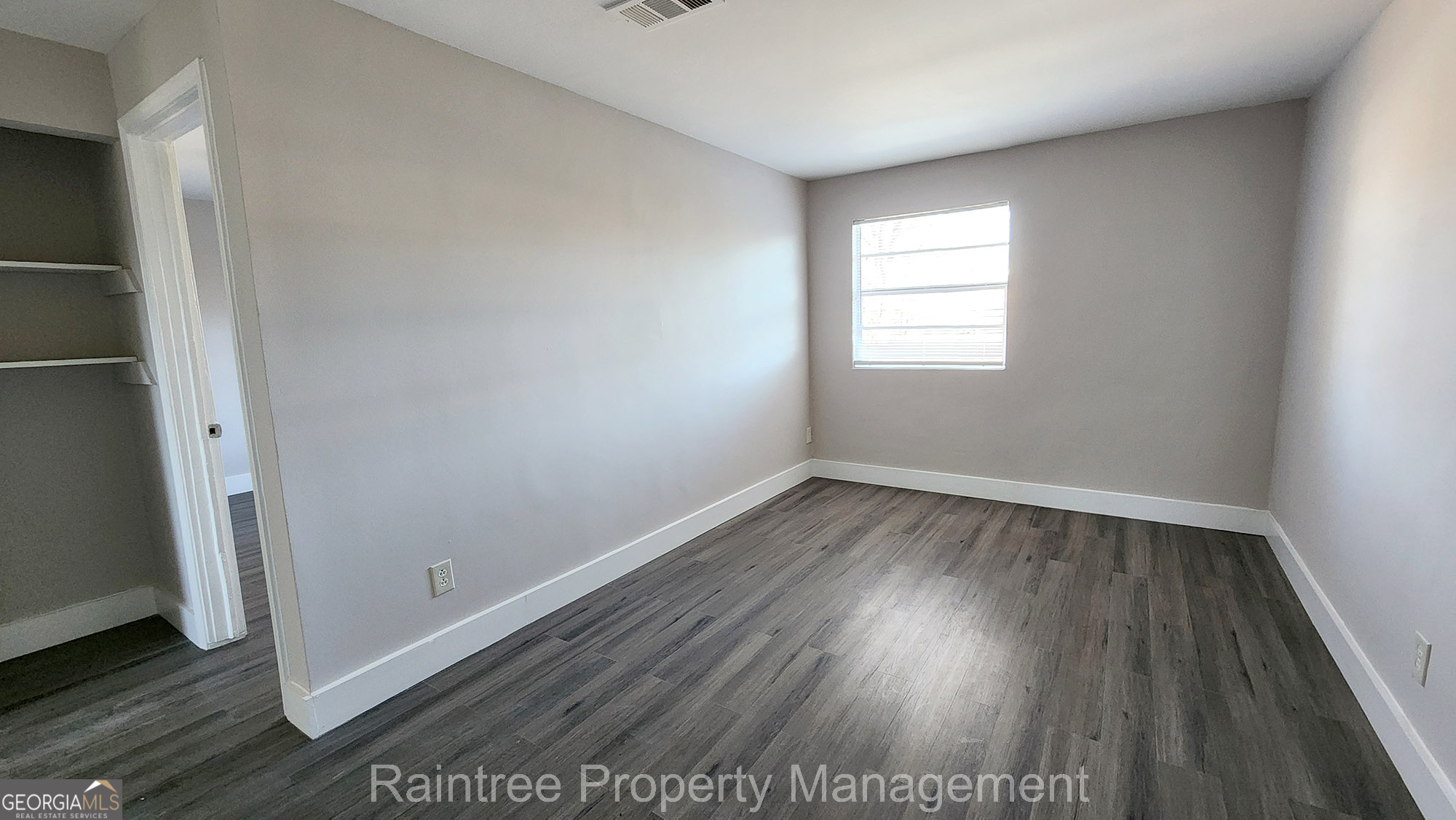 20 Griffin Street Northwest, Unit 12 Atlanta, GA 30314 - Photo 2 of 10 an empty room with wooden floor and windows