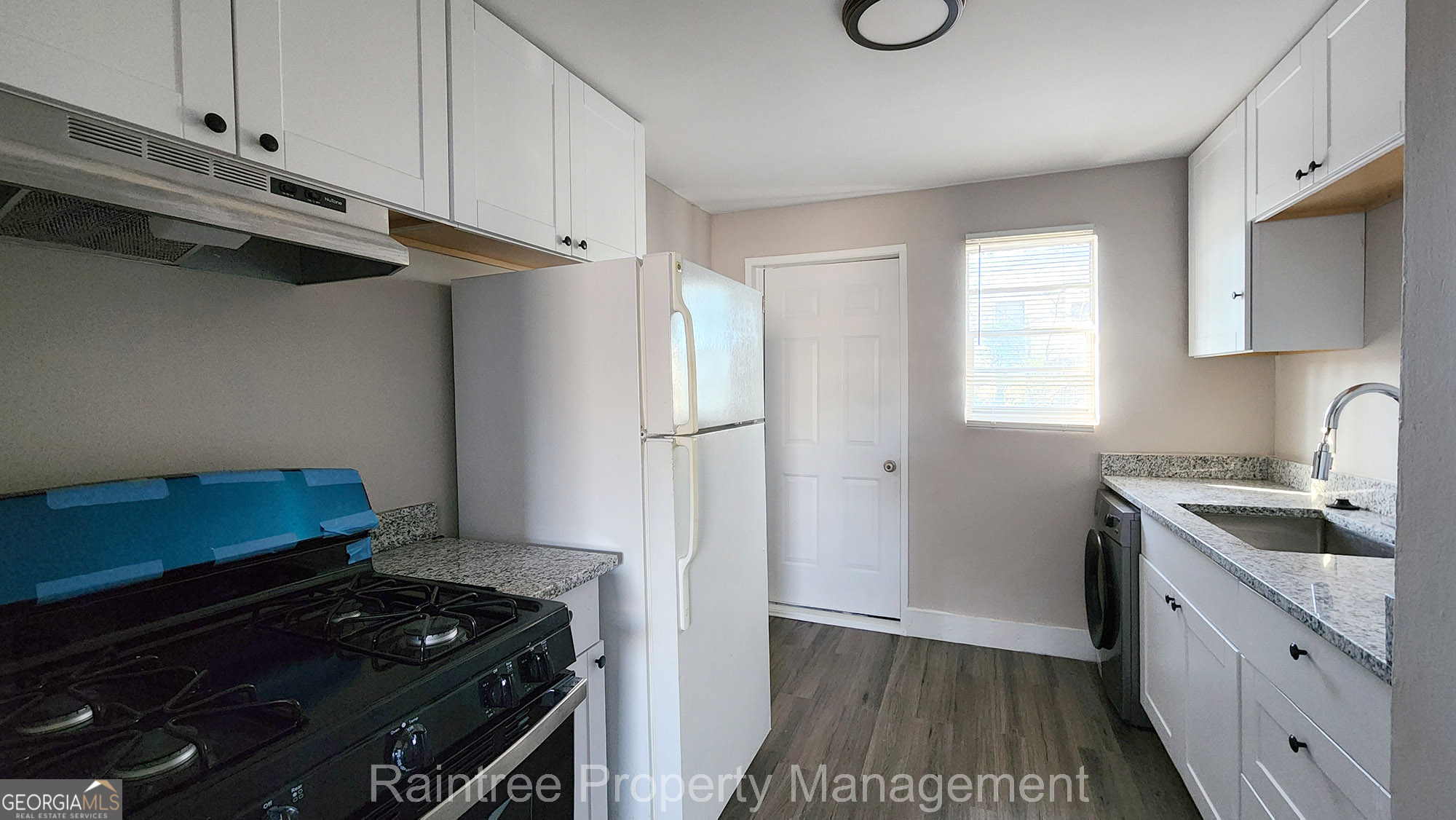 20 Griffin Street Northwest, Unit 12 Atlanta, GA 30314 - Photo 5 of 10 a kitchen with granite countertop a stove and a refrigerator