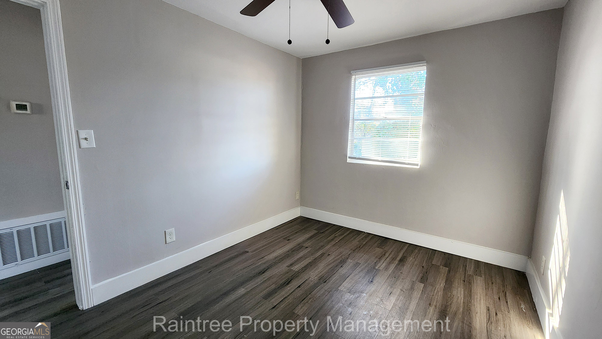 20 Griffin Street Northwest, Unit 12 Atlanta, GA 30314 - Photo 8 of 10 an empty room with a window and wooden floor