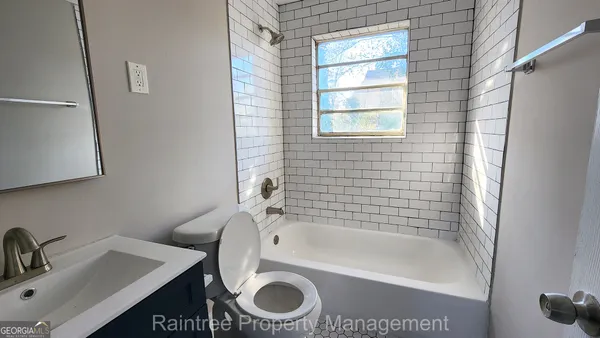 a bathroom with a sink a toilet and bathtub